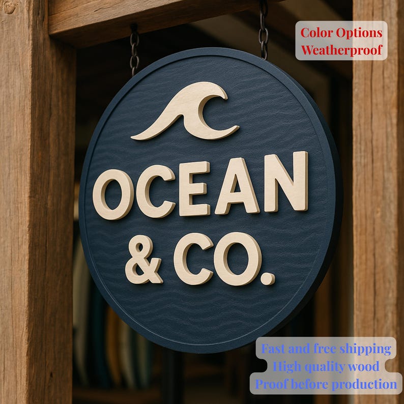 May include: A circular navy blue sign featuring the text "OCEAN & CO." in raised beige lettering, with a beige wave graphic. The sign is suspended by chains and attached to a wooden frame. The sign is weatherproof.