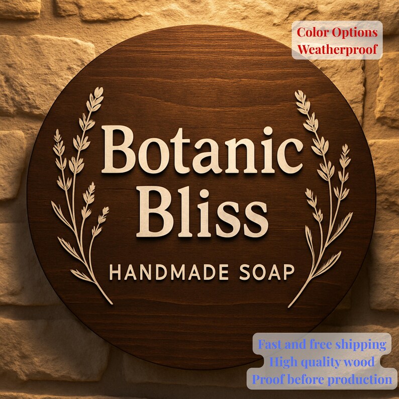 May include: A circular wooden sign, stained dark brown, with the words "Botanic Bliss HANDMADE SOAP" in white. It features white floral embellishments. The text "Color Options Weatherproof" is in the upper right corner of the sign.