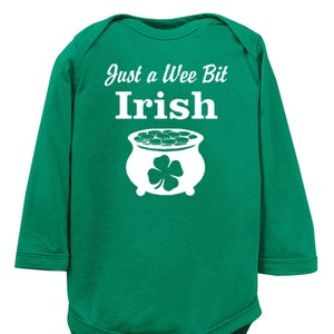 May include: Green long-sleeve baby onesie with white text that reads "Just a Wee Bit Irish" and a white pot of gold with a shamrock.