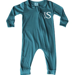May include: Teal blue baby sleeper with a zipper closure and long sleeves. The sleeper has white embroidered initials "EJS" on the front.