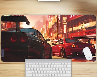 May include: A black and red sports car mousepad with a city background. The mousepad features two cars, one black and one red, driving down a street lined with buildings. The buildings have Japanese characters on them.