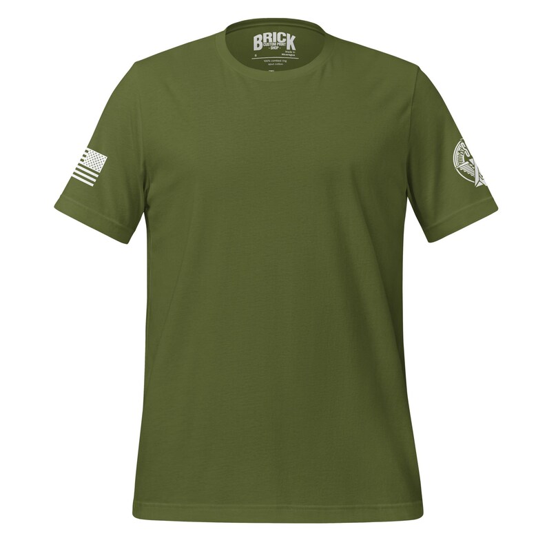 May include: A green short-sleeved t-shirt with a white American flag on the left sleeve and a white logo on the right sleeve. The logo says "Brick".