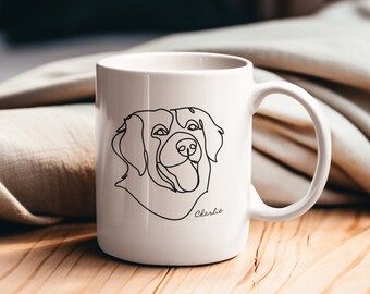 May include: White ceramic mug with a black line drawing of a dog's head and the name "Charlie" printed on the bottom.
