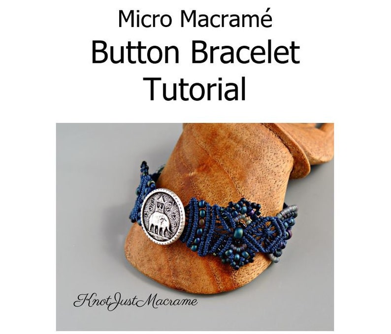 May include: A close-up of a blue and silver macrame bracelet with a button featuring an elephant design. The bracelet is on a wooden display stand. The text "Knot Just Macrame" is visible below the bracelet.
