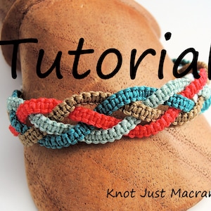May include: A tutorial for making a macrame bracelet with four strands of cord in red, teal, and brown colors. The bracelet is displayed on a wooden surface with the text "Tutorial" above it and "Knot Just Macrame" below it.