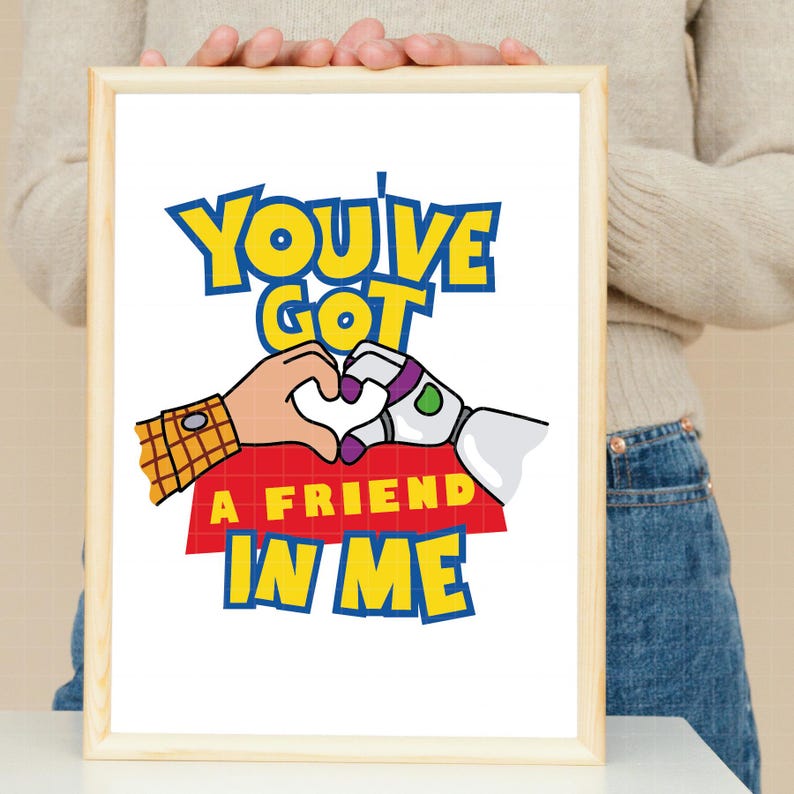 May include: A white printable poster with a cartoon image of Woody and Buzz Lightyear from Toy Story. The characters are holding hands in the shape of a heart. The text on the poster reads "You've Got A Friend In Me".