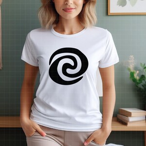 May include: White t-shirt featuring a large black spiral design. The graphic is centered on the front of the shirt. The shirt has short sleeves and a crew neck.