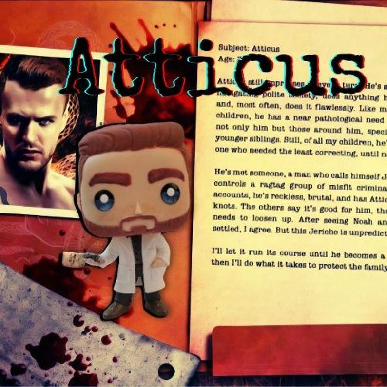 May include: A stylized vinyl figure of a man with brown hair and a beard, wearing a white lab coat over a dark shirt and pants, holding a small object. The figure is set against a background featuring a photograph of a man and printed text.