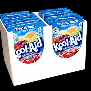 May include: A white, two-compartment organizer filled with blue packets of Kool-Aid Tropical Punch drink mix. Each packet features a colorful illustration of fruit and the Kool-Aid logo. The packets are displayed against a black background.