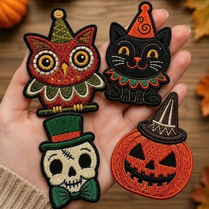 May include: Four embroidered patches featuring Halloween themes: a red owl in a green party hat, a black cat in an orange party hat with a ruffled collar, a skull wearing a green top hat and bow tie, and an orange jack-o'-lantern with a brown hat.