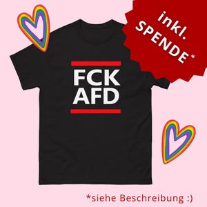 May include: Black t-shirt with the white text "FCK AFD" in a bold font, with a red line above and below the text. The image includes two rainbow heart graphics and text in German.