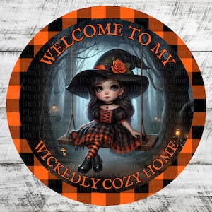 May include: Circular Halloween decoration featuring a cartoon witch on a swing in a forest scene. The design includes orange and black plaid edging and the words "WELCOME TO MY WICKEDLY COZY HOME".