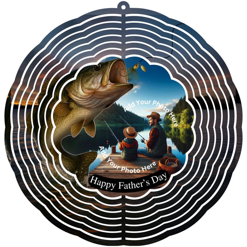 May include: A circular metal wind spinner with a fishing theme. The design shows a large fish leaping towards a lure, with a father and child fishing on a dock. Text reads "Happy Father's Day".