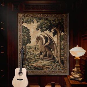 May include: Acoustic guitar leaning against a tapestry featuring a dragon in a landscape scene. The tapestry is framed and hangs on a dark wood paneled wall. A decorative lamp with a cream-colored shade sits on a table.
