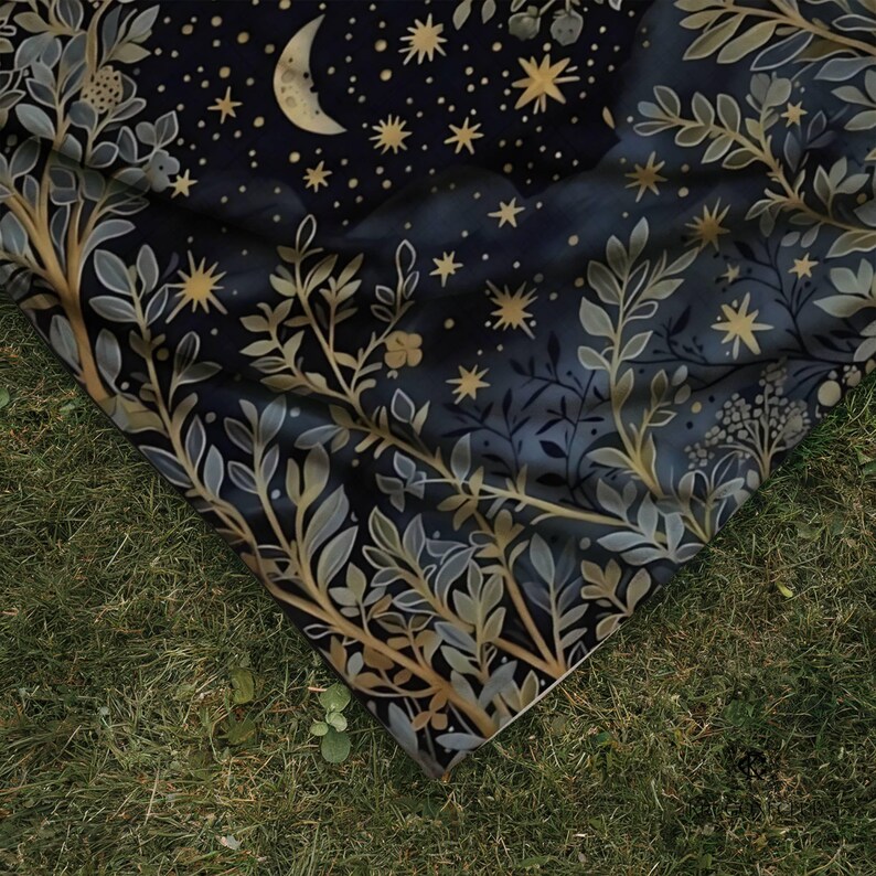 and fabric drape, botanical sage green foliage with crescent moon and golden stars on dark navy blue background, outdoor nature photography demonstrating cozy witchy boho blanket quality and flexibility