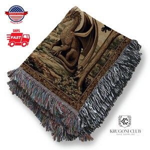 May include: A woven throw blanket featuring a detailed illustration of a dragon in shades of brown, tan, and green. The blanket has a fringed edge with multiple colors. The dragon is set against a backdrop of a forest scene.