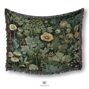 May include: A woven throw blanket featuring a botanical design with yellow poppies and various green foliage. The blanket has a dark background and a fringed edge. The design includes detailed illustrations of flowers and leaves.