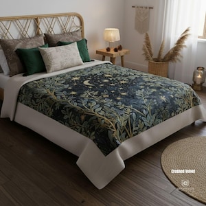 May include: A bed with a dark blue crushed velvet bedspread featuring a celestial design of stars and a crescent moon, with green and gold foliage. The bed is made up with several pillows in shades of green, brown, and cream. The bed frame is made of woven rattan.