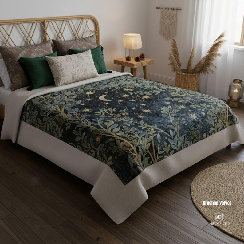 May include: A bed with a dark blue crushed velvet bedspread featuring a celestial design of stars and a crescent moon, with green and gold foliage. The bed is made up with several pillows in shades of green, brown, and cream. The bed frame is made of woven rattan.
