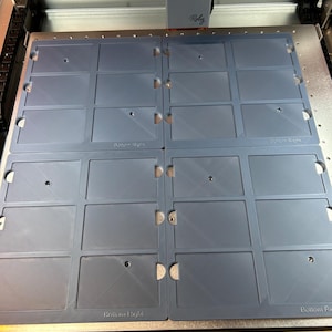 May include: A close-up of a blue plastic sheet with multiple rectangular cutouts. The sheet is labeled "Bottom Right" in the bottom right corner.