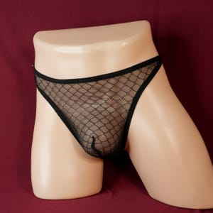May include: Black mesh underwear with a geometric pattern.