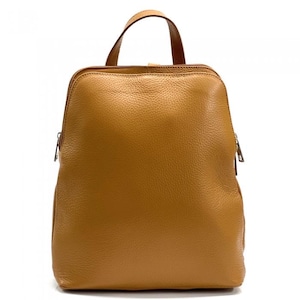 May include: A tan leather backpack with a top handle and two adjustable shoulder straps. The bag has a zipper closure and a textured surface. The hardware is silver-toned. The bag is approximately 12 inches wide and 14 inches tall.