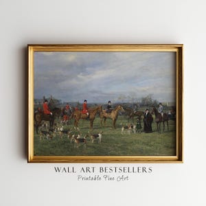 May include: A framed print of a hunting scene with riders on horseback, hounds, and figures in period attire. The artwork is set in a grassy field under a cloudy sky. The frame is gold, and the text "WALL ART BESTSELLERS Printable Fine Art" is at the bottom.