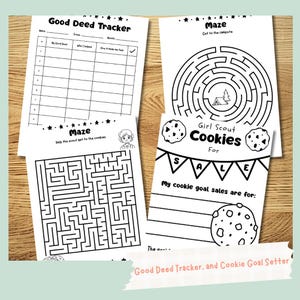 May include: A collection of black and white activity sheets. One sheet is a "Good Deed Tracker", another is a maze, and a third is a "Girl Scout Cookies For Sale" goal setter. The sheets are on a wooden surface.