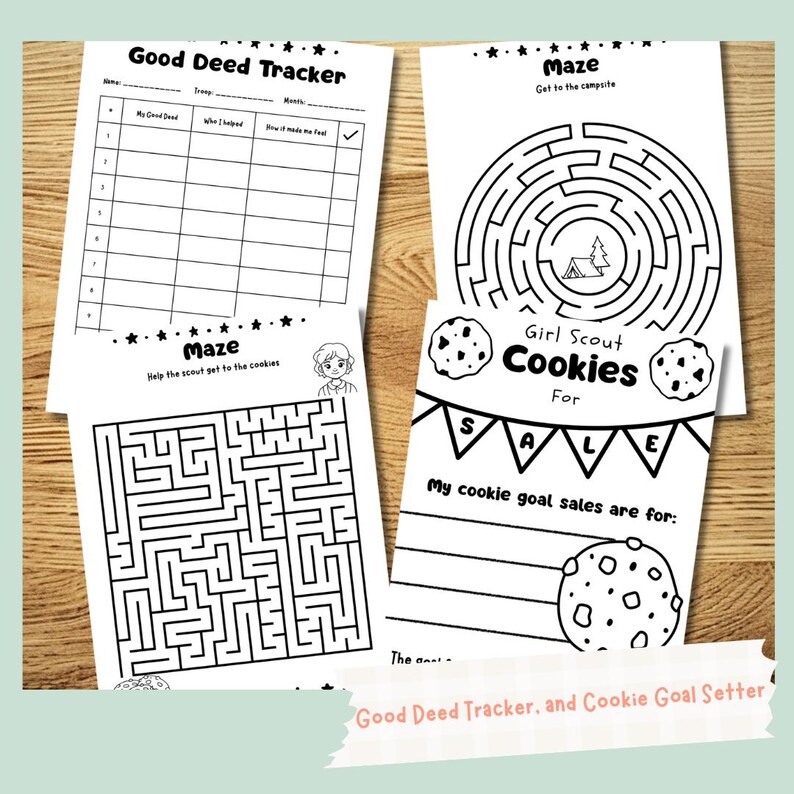 May include: A collection of black and white activity sheets. One sheet is a "Good Deed Tracker", another is a maze, and a third is a "Girl Scout Cookies For Sale" goal setter. The sheets are on a wooden surface.
