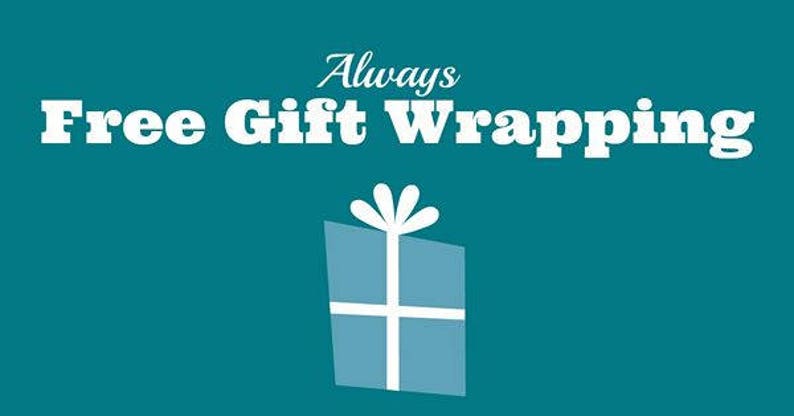 May include: A teal graphic featuring the white text Always Free Gift Wrapping centered above a stylized light blue gift box icon with a white ribbon and bow. The design uses a bold serif font for the main text and a script font for the word Always.