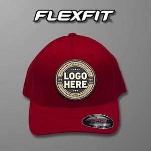 May include: Red baseball cap with a black and white logo patch that says "LOGO HERE". The Flexfit logo is on the back of the cap.