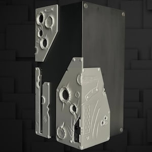May include: A dark gray computer case with silver-colored, irregularly shaped panels attached. The panels have circular and oblong cutouts, giving a textured, industrial appearance. The case is set against a dark, geometric background.