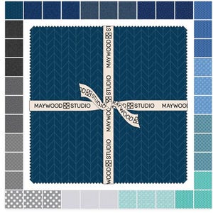 May include: A bundle of fabric squares in various shades of blue and gray. The central square features a dark blue chevron pattern, tied with a ribbon printed with "MAYWOOD STUDIO". Additional fabric swatches surround the main bundle, showcasing different patterns and colors.