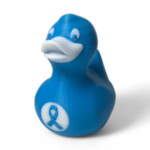 May include: A blue rubber duck with a white beak and eyes. The duck has a blue ribbon on its chest.