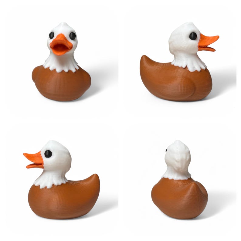 May include: A brown rubber duck with a white head and orange beak. The duck has a white feathered design around its neck, resembling an eagle.