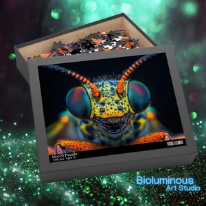 May include: A 16x20 inch puzzle featuring a close-up of an insect's face with vibrant colors. The insect has large, multi-colored eyes and intricate patterns. The puzzle is in a gray box with the text "16x20 Puzzle 500 pcs Ages 9+".
