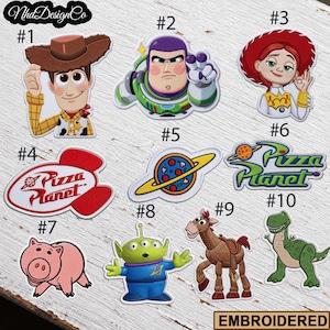 May include: Embroidered patches featuring characters and logos from the animated film series. Includes Woody, Buzz Lightyear, Jessie, Hamm, an alien, Rex, and Pizza Planet designs. Each patch is numbered for easy selection.