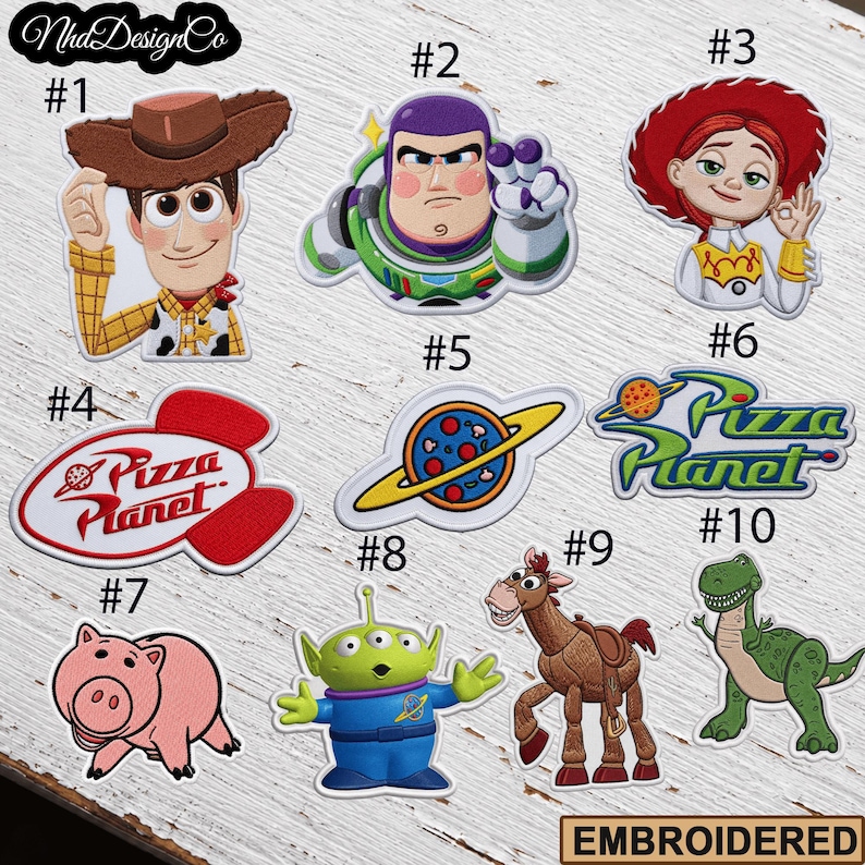 May include: Embroidered patches featuring characters and logos from the animated film series. Includes Woody, Buzz Lightyear, Jessie, Hamm, an alien, Rex, and Pizza Planet designs. Each patch is numbered for easy selection.