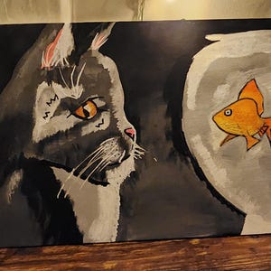 old sad cat and a goldfish