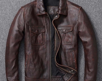 May include: A brown leather jacket with a zipper closure and two large flap pockets. The jacket has a distressed look and a collar.