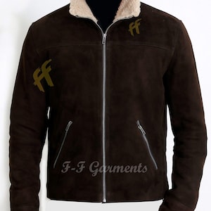 May include: A brown suede jacket with a faux fur collar and zip closure. The jacket has two pockets on the front and the text "F-F Garments" is printed on the front. The jacket has two gold "FF" logos on the front and one on the left sleeve.