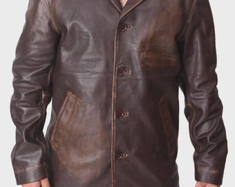 May include: A brown leather jacket with a button-up front, notched lapels, and two front pockets. The jacket has a distressed appearance, with variations in color and texture. The jacket is worn over a collared shirt.