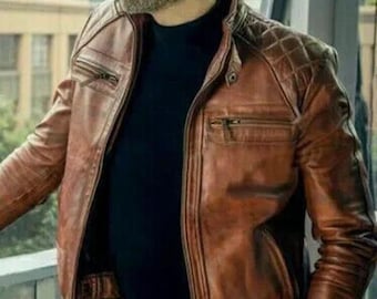 May include: A brown leather jacket with a quilted design on the shoulders and a zipper closure. The jacket has a stand-up collar and multiple pockets.
