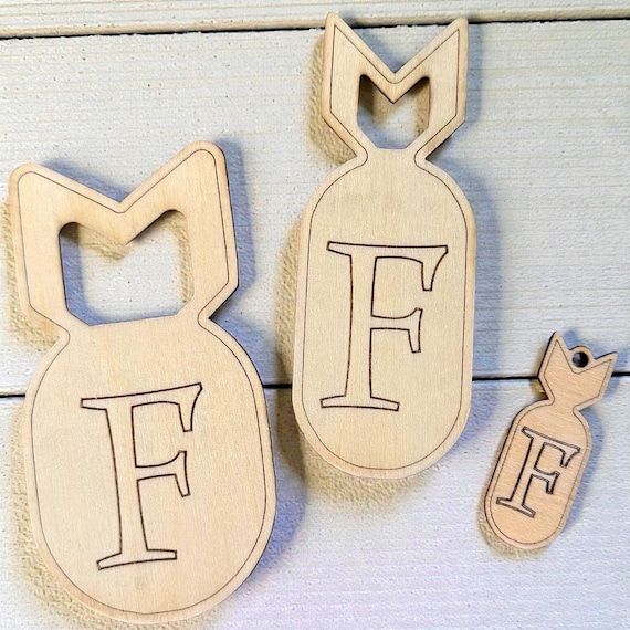 A hand-cut wooden 'F-Bomb' that sits on your desk like a tiny trophy — tactile, genuinely funny, and free personalization makes it a great gift.