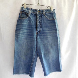 May include: A pair of blue denim shorts with a high waist and a frayed hem.