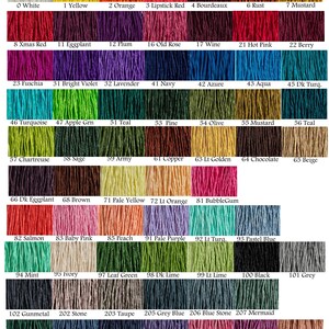 May include: A color chart displaying a wide array of yarn colors, each labeled with a number and name. Colors range from white and yellow to deep mauve and black, including shades of red, blue, green, and purple. The chart is designed to showcase the variety of available yarn colors.