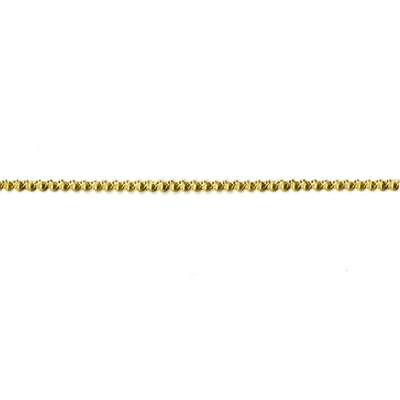 May include: A gold chain with a beaded design.
