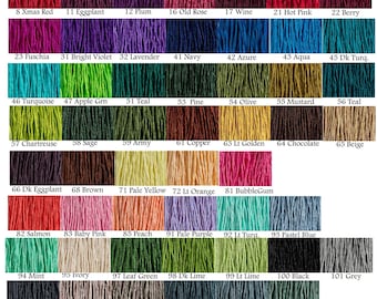 May include: A color chart displaying a wide array of yarn colors, each labeled with a number and name. Colors range from white and yellow to deep mauve and black, including shades of red, blue, green, and purple. The chart is designed to showcase the variety of available yarn colors.