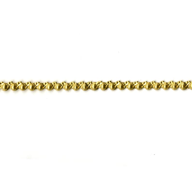 May include: Gold beaded trim with a decorative pattern. This trim is perfect for adding a touch of elegance to crafts, home decor, and clothing.
