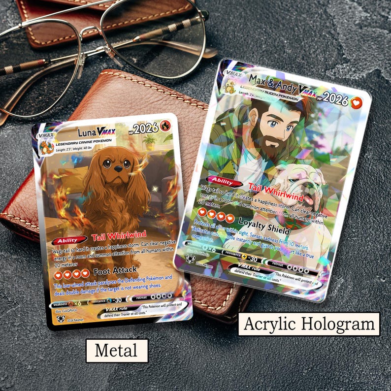 May include: Two rectangular trading cards featuring custom illustrations. The left card, labeled Metal, depicts a brown Cavalier King Charles Spaniel. The right card, labeled Acrylic Hologram, shows a person with a beard and a bulldog. Both cards display text including Max & Andy VMAX, Luna VMAX, and various game statistics.